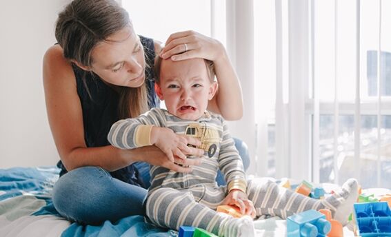 Mom trying to comfort crying baby